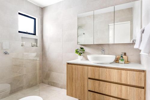 a bathroom with a sink and a shower at Station & Surf 3BR Wollongong Townhouse in Wollongong