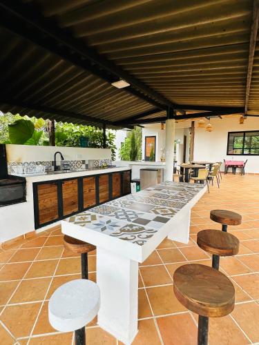 a large white table and chairs on a patio at La Capilla EcoHotel in Moniquirá