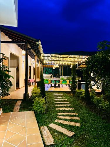 a backyard at night with a table and a patio at La Capilla EcoHotel in Moniquirá