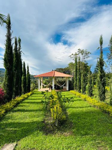 a garden with a pavilion in the middle of a field at La Capilla EcoHotel in Moniquirá