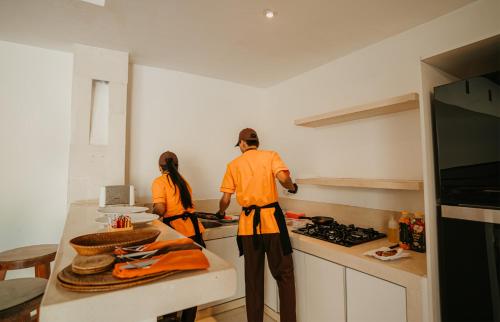 two people standing in a kitchen preparing food at Bvilla Spa in Seminyak