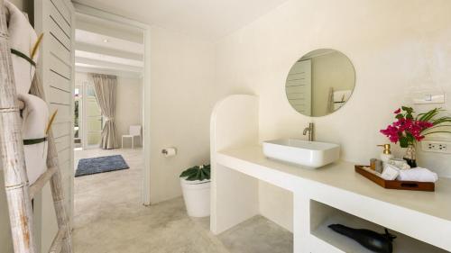 a bathroom with a sink and a mirror at Aqua Vista 02 - 4BR Villa Near the Beach in Amphoe Koh Samui