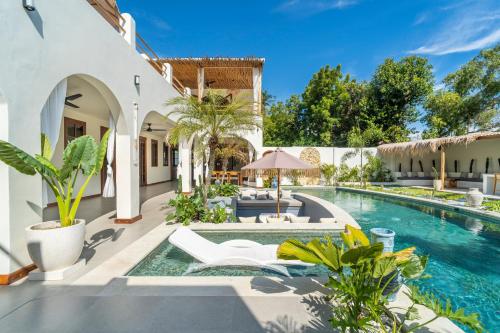 an outdoor patio with a swimming pool and a villa at Luxury 3BR Noa Villa Private Pool in Gili Air