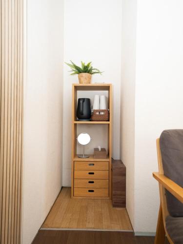 a room with a shelf with a lamp on it at Setouchi Inn Minamoみなも in Takamatsu