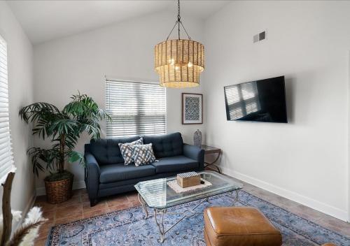 a living room with a blue couch and a table at Seaside Serenity 3-Bedroom Shore home 2 blocks to the beach and boardwalk in Seaside Heights
