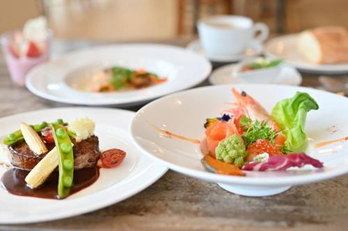 a table with three plates of food on it at Hotel Flex in Hiroshima