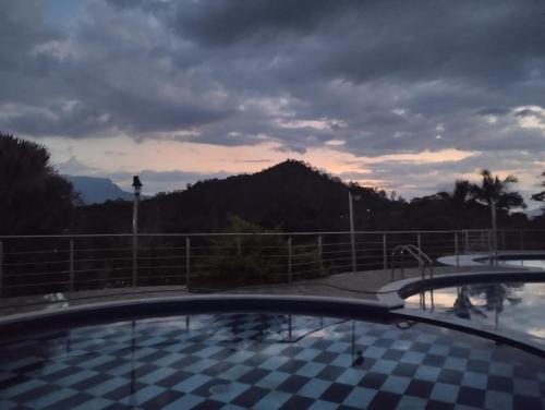 a resort swimming pool with a view of a mountain at Finca La Vistosa in Sasaima