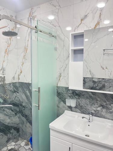 a bathroom with a sink and a shower at Apartment lux in Samarkand