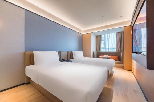 Una cama o camas en una habitación de Orange Hotel Beijing Beiqing Road Zhongguancun Eco-friendly Park