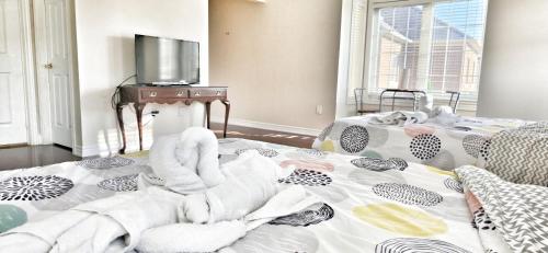 a bedroom with a bed with towels on it at luxurious Private Master bedroom in Markham