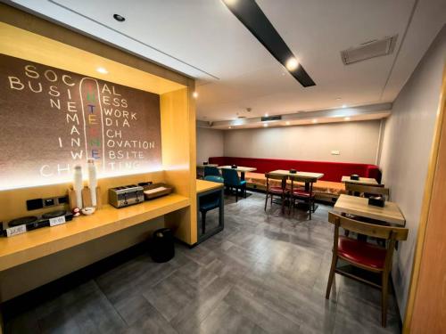 a restaurant with tables and chairs and a chalk board at Ibis Beijing Shichahai Gulou Street Subway Station Hotel in Beijing