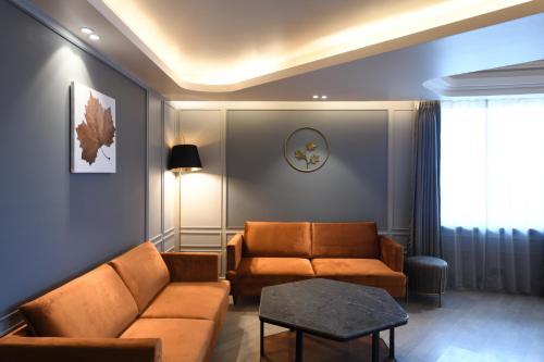 a living room with a couch and a table at Ramada Encore by Wyndham Rajbagh Srinagar in Srinagar