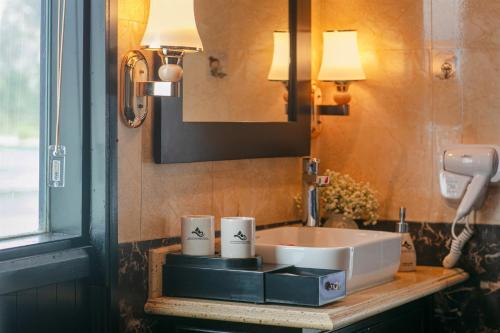 a bathroom with a sink and a mirror at Halong Arcadia Cruise in Ha Long