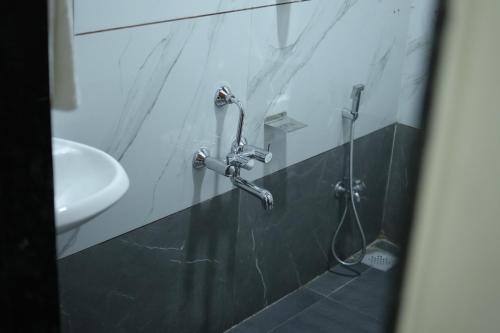 a bathroom with a shower and a sink at Mango Resort Washi Hills in Kolhapur