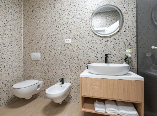 a bathroom with a sink and a toilet and a mirror at Villa SENKA in Rogotin