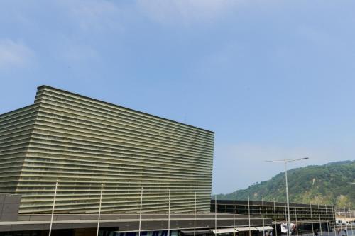 a large building with a mountain in the background at Pension Kursaal in Donostia-San Sebastián