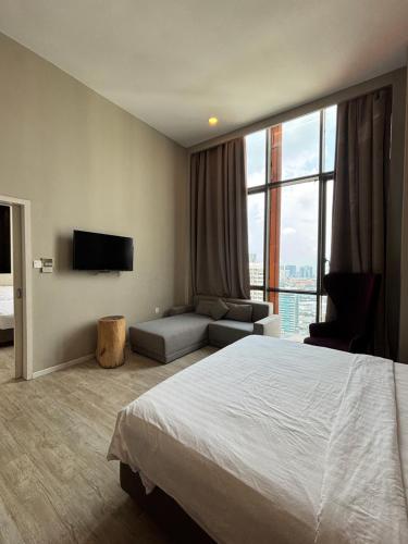 a hotel room with a bed and a large window at QQ Empire Damansara hotel room in Petaling Jaya