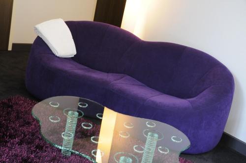 a purple chair with a guitar next to it at Demeures & Châteaux La Belle Meuniere in Royat