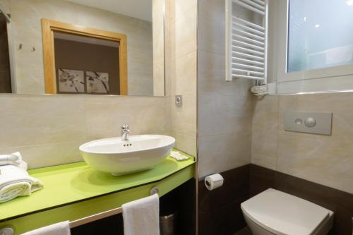 a bathroom with a sink and a toilet at Pension Kursaal in Donostia-San Sebastián