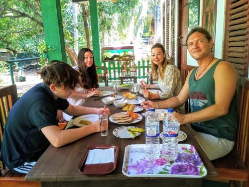 a group of people sitting around a table at Jm Resort in Dambulla