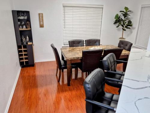 a dining room with a wooden table and chairs at Arlington Social in Arlington