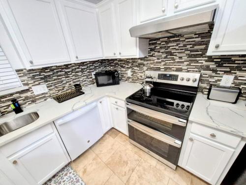 a kitchen with white cabinets and a stove top oven at Arlington Social in Arlington