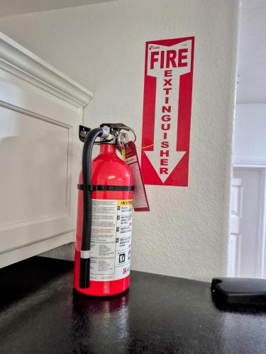 a fire extinguisher sitting on a counter next to a wall at Arlington Social in Arlington
