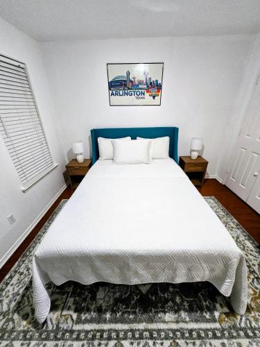 a bedroom with a large white bed and two tables at Arlington Social in Arlington