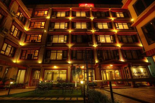 a large building with lights on it at night at Mandala Boutique Hotel in Kathmandu