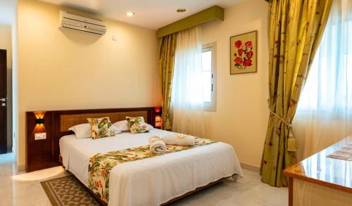 a bedroom with a bed and a window at Ocean Pearl Villa in Anse Royale