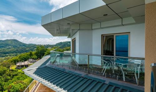 a balcony of a house with a view at Ocean Pearl Villa in Anse Royale