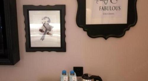 a mirror on a wall with a picture of a woman at Xana Hotelle·Tianshui Shangyi Plaza in Tianshui