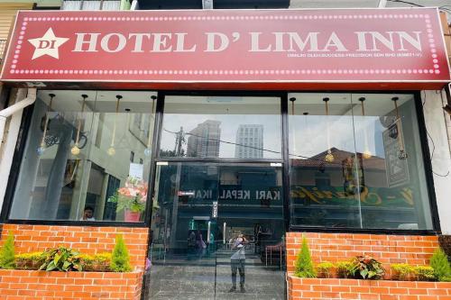 a person walking in front of a hotel linemaan at Hotel Dlima Inn Bukit Bintang in Kuala Lumpur