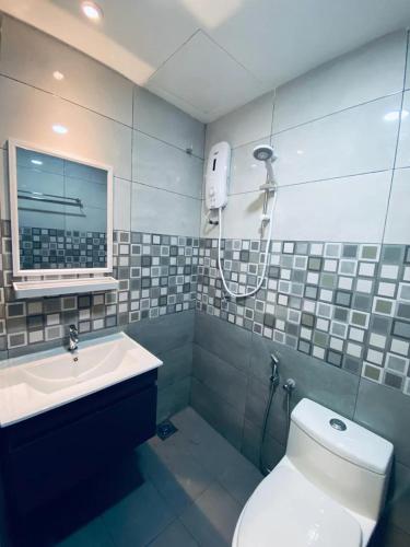 a bathroom with a toilet and a sink at Hotel Dlima Inn Bukit Bintang in Kuala Lumpur