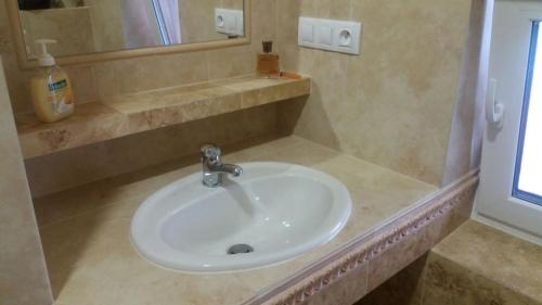 a bathroom with a white sink and a mirror at Ubytování pod Pálavou in Horní Věstonice