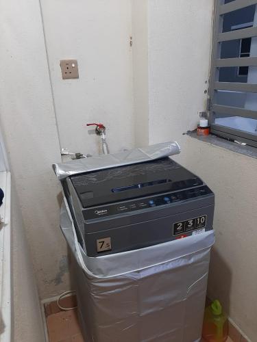 a fax machine sitting on top of a container at MK Homestay Sunway in Ipoh