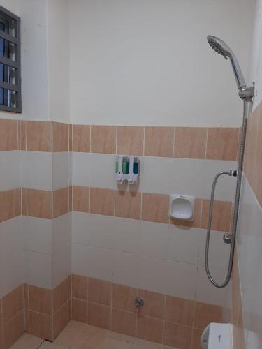 a bathroom with a shower with a shower head at MK Homestay Sunway in Ipoh