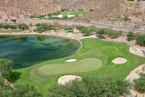 an aerial view of a golf course with a body of water at Puerta Cortés Residences by Lumina in La Paz