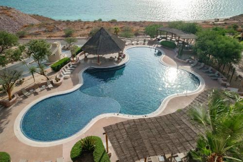an overhead view of a swimming pool at a resort at Puerta Cortés Residences by Lumina in La Paz