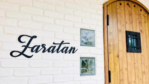 a brick wall with a sign that reads iceland at ZARATAN in Motobu