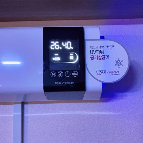 an alarm clock sitting on top of a shelf at Raon House Paju in Paju