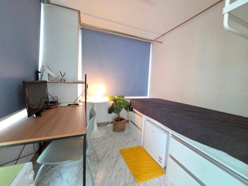 a bedroom with a bed and a desk and a window at Raon House Paju in Paju