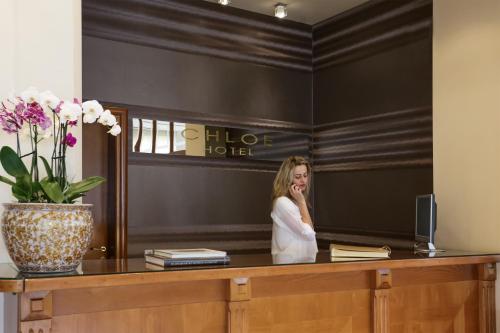 a woman is standing in front of a mirror at Chloe Luxury Hotel in Kastoria