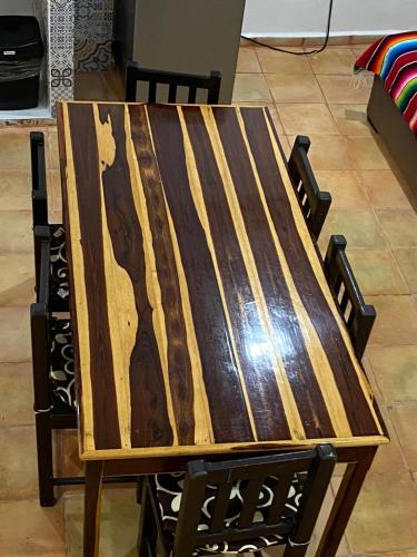 a wooden table sitting on top of a chair at Vistalmar House in Isla Mujeres