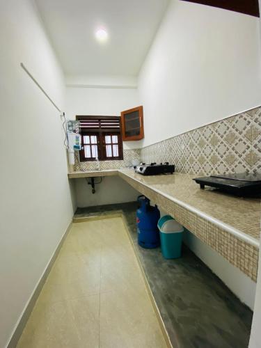 a small kitchen with a counter and a window at TK Homes in Badulla