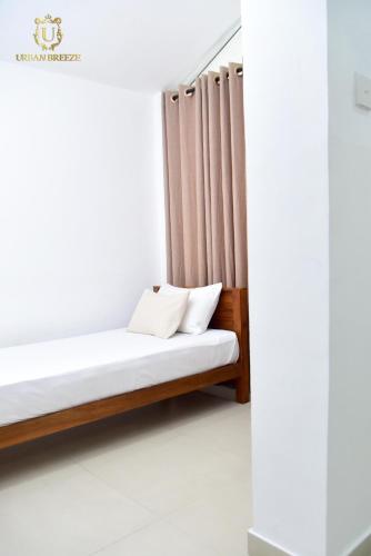 Postel nebo postele na pokoji v ubytování Urban Breeze