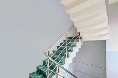 a staircase in a house with green glass treads at Collection O Kurnool Formerly Sai Priyanka Inn in Kurnool