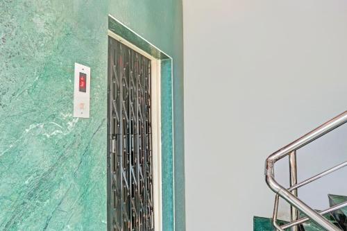 a door in a room with a green wall at Collection O Kurnool Formerly Sai Priyanka Inn in Kurnool