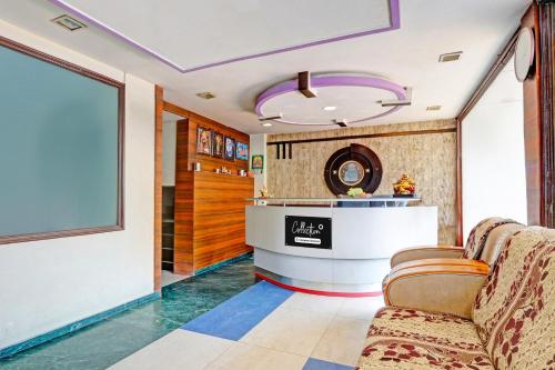 a lobby with two chairs and a counter in a room at Collection O Kurnool Formerly Sai Priyanka Inn in Kurnool
