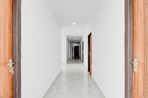 an open hallway with white walls and white floors at Super Townhouse B N Reddy Formerly Capitol Stay Inn in Surūrnagar